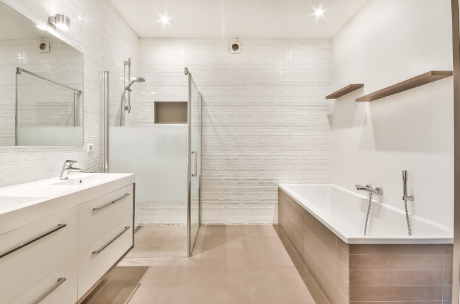 Bathroom remodel in Moorpark with tiled walls, glass shower, and built-in tub